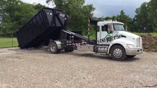 Kenworth Hooklift Picking up 30 Yard Dumpster