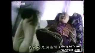 woman performs tickle torture on an asian man