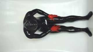 Full latex doll boy in a zipless latex catsuit, no way out.