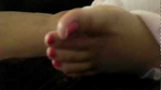 Wife's sleeping feet with pink toenail polish