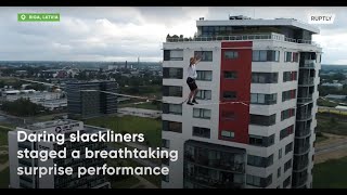Latvian slackliners wow flat residents with death-defying performance