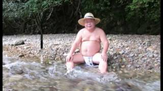 Chubby nice old man taking a bath outdoor