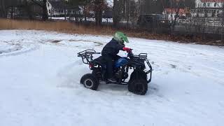 7yo on Atv doing donuts in the snow