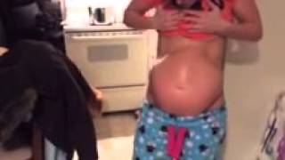 Pregnant woman flexes abs