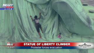 DRAMATIC CAPTURE: Protester Climbs The Statue Of Liberty