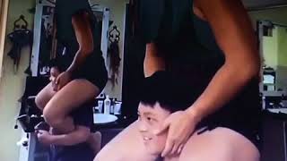 Kid does squat whiles mom on shoulder