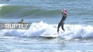 USA: Surfing Santas make waves at Cocoa Beach Xmas tradition