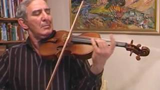 Michail Kazinik tries out a violin made in 1741 by Bartolomeo