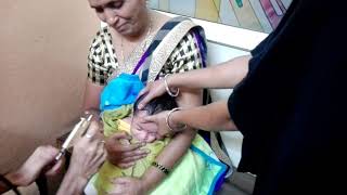 Baby's ear piercing by professionals