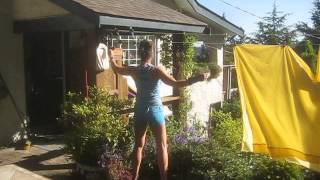 Sweet  Woman Hanging Laundry on her Clothes Line