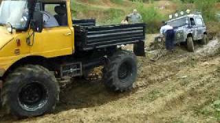 Unimog pulling landrover out of the sticky stuff.