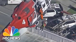 Watch Firefighters Rescue Residents From Roof Of Burning High-Rise | NBC News