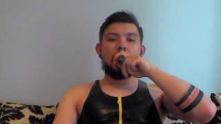 Lighting cigar in rubber suit