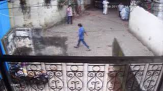 Woman urinating in the building compuond