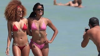 Claudia Jordan wears tiny string bikini while frolicking in the Miami surf. March 2015