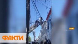 Спасательная операция в США: енот залез на крышу и застрял в проводах