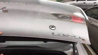 Штатная кнопка багажника  Lancer X