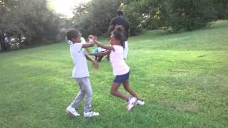 Two  little girls fighting outside