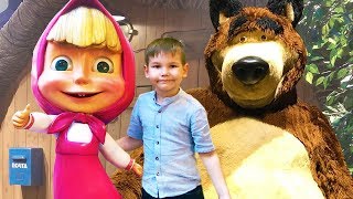 Vlad playing in toy store with big dolls of cartoon characters