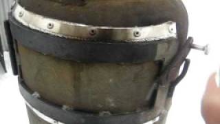 Gas bottle wood stove with bus exhaust for chimney