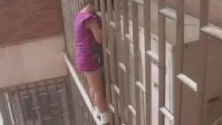 Chinese girl rescued hanging from railings on skyscraper