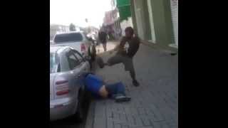 Drunk Bum Tries to Kick a Man Lying on The Ground & Falls over