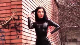 Femme Fatale In a Black Latex Catsuit
