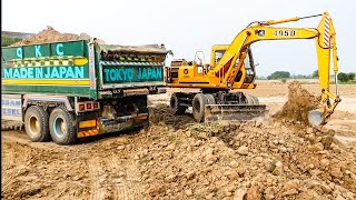 Small excavator filling huge truck damper 30, 2019