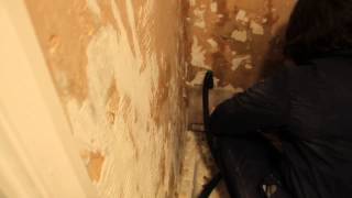 Using a wallpaper steamer, we finally removed tile adhesive from the remaining walls
