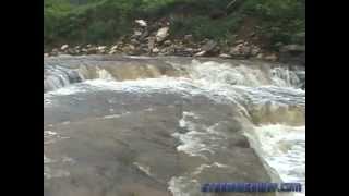 Sudden flash flood wave fills a creek bank-to-bank in seconds - multiple camera angles
