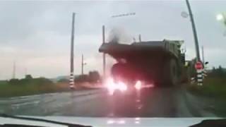 Huge mining dumptruck hits overhead electric wires causing the tyres to explode