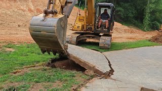Excavator Removing Concrete Slab