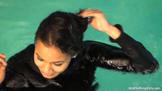 Naomi in pool with boots, jeans and pullover
