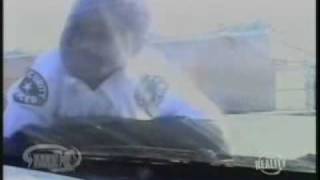 Gary Coleman jumps on a car working as a security guard