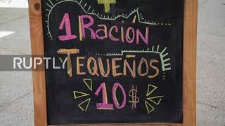 Caracas residents react to latest economic data pulling country out of long-term hyperinflation