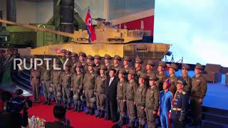 Missiles displayed at defence exhibition as Kim Jong-un vows to build 'invincible military' *STILLS*