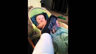 Owen fascinated by mom's foot.