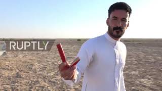 Bullseye! Talented Iraqi shooter uses mirror to pin targets facing backwards