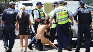 Nude woman strips off during Australia Day protest.