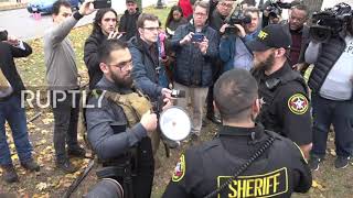 Protester armed with assault rifle ordered by police to leave court area during Rittenhouse trial