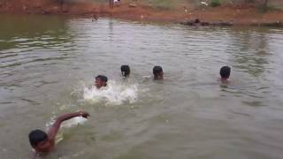 Village Boys Enjoy a Summer Swim In A Village Pond