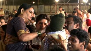 Force feeding raw fish to a baby in Hyderabad, India