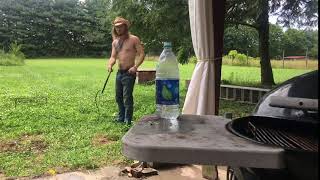 Guy in Cowboy Hat Uses Whip to Knock Cap off Water Bottle - 1056839