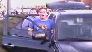 Drunk Delaware blue Hens pees on his car