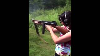 Girl shooting Thompson sub machine gun