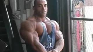 Bodybuilder Dennis James posing massive muscle