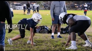 Twelve-year-old Philadelphia football prodigy towers over teammates on the field