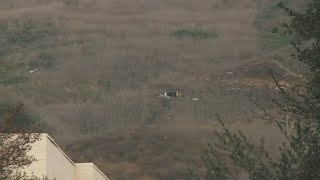 Authorities prepare body bags at Kobe Bryant helicopter crash site | AFP