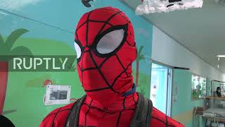 Italy: Superheroes climb down Milan hospital in spectacle for patients