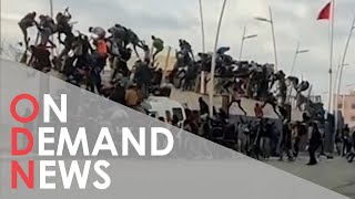 Dozens of Migrants Dead After Fence COLLAPSES
